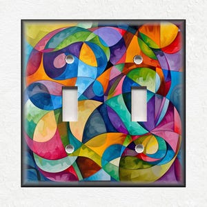 May include: A colorful abstract design with swirling lines and shapes in shades of blue, green, yellow, orange, pink, and purple. The design is on a light switch plate.