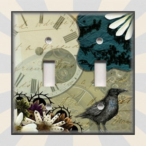 May include: A light switch cover with a vintage design featuring a clock face, a raven, and floral elements. The background is a collage of old paper and fabric with a teal blue color scheme. The text "to the friend" is visible on the cover.