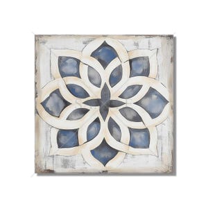May include: A square canvas painting with a white background and a blue and white geometric design in the center. The design is a stylized flower with eight petals.