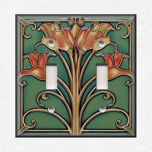 May include: A double light switch cover with a decorative design featuring stylized orange flowers and green leaves on a teal background.