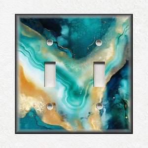 May include: A light switch cover with an abstract design featuring swirling blue, green, and gold colors. The design resembles a marble or agate stone.