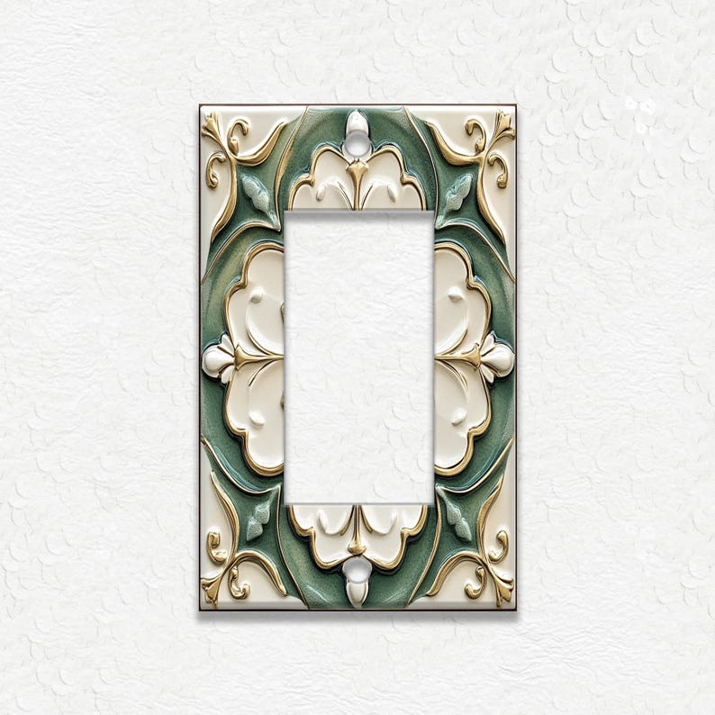 May include: A decorative light switch cover with a floral design. The cover features a rectangular shape with a central opening. The design incorporates white, green, and gold colors, with a raised, textured pattern. The background is white.
