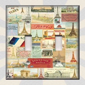 May include: A decorative light switch cover featuring a collage of vintage postcards and illustrations of Paris landmarks. The design includes images of the Eiffel Tower, Arc de Triomphe, and other Parisian scenes, with text like "Souvenir de Paris".
