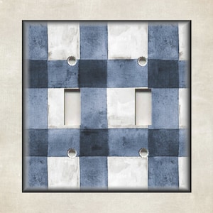 May include: A light blue and white checkered light switch cover with two toggle switches.