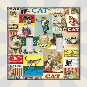 May include: A light switch cover with a collage of vintage cat illustrations and advertisements. The cover features images of cats, kittens, and cat-themed products, including cat food, cat toys, and cat safety matches. The text on the cover includes the words "CAT", "meow", "kitten", "C is for CAT", and "National Cat Week".