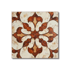 May include: A square ceramic tile with a white background and a brown floral design. The design features a central cross shape with four curved petals extending from each arm.