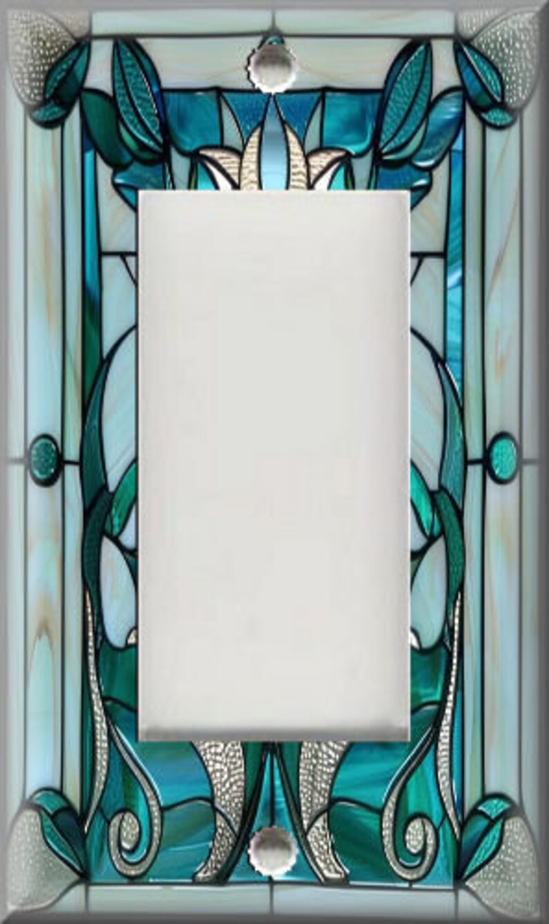 May include: A decorative light switch cover with a stained glass design. The cover features a rectangular center with a detailed border in shades of teal, white, and silver. The design includes floral and abstract patterns, creating a unique and artistic look.