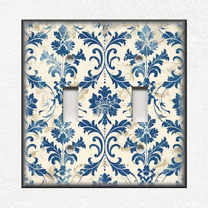May include: A white light switch cover with a blue and white damask pattern.
