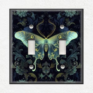 May include: A light switch cover with a dark blue background and a gold and green butterfly design.