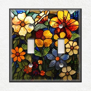 May include: A colorful stained glass light switch cover featuring a floral design with various flowers in shades of red, yellow, blue, orange, and green.