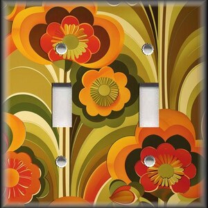 May include: A decorative light switch cover featuring a retro floral design. The cover has a vibrant pattern of orange, red, brown, and green flowers and leaves. The cover has two light switch openings and silver screws.
