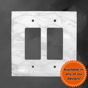 May include: White marble switch plate with two rectangular cutouts for light switches. The plate has four screw holes and is available in a variety of designs.