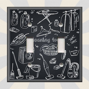 May include: Black light switch cover with a white doodle design of cleaning supplies, including a broom, mop, vacuum cleaner, laundry basket, iron, and washing machine. The text "leaning to" is visible on the switch cover.