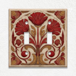 May include: A decorative double light switch cover featuring a floral design in red, gold, and cream colors. The design includes stylized flowers and leaves, with a vintage or antique aesthetic. The cover has two switch openings.