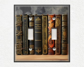 May include: A light switch cover featuring a row of vintage, leather-bound books with gold accents. The books have titles like "Momilasse Th Rotehss" and "NOUBWILIUS Y Pwera mur".