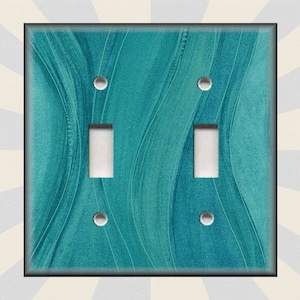 May include: A teal blue light switch cover with a wavy pattern. The cover has two toggle switches and four screw holes.