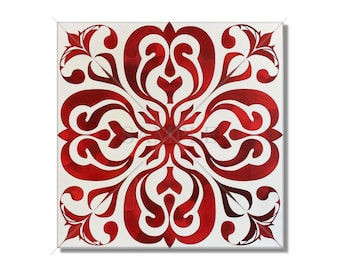 May include: Square tile with a symmetrical design. The tile features a bold red floral pattern against a white background. The design is composed of stylized leaves and swirling shapes, creating a decorative and eye-catching visual.