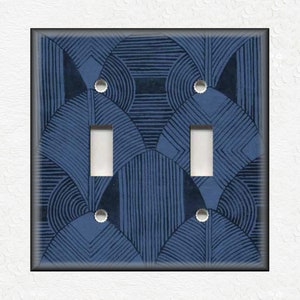 May include: A blue and white geometric patterned light switch cover with two toggle switches.