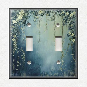 May include: A light blue and green floral design light switch cover with white flowers and vines. The switch cover has two toggle switches.