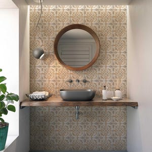 May include: A bathroom vanity with a round wooden mirror, a black sink, and a wooden countertop. The wall behind the vanity is tiled with a patterned tile in shades of beige and brown.