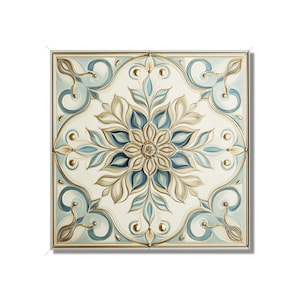 May include: A square tile with a white background and a blue and gold floral design. The design features a central flower with petals that are a light blue color and a gold center. The flower is surrounded by leaves that are a light gold color.