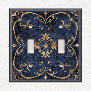 May include: A decorative light switch cover with a blue and gold design. The design features intricate floral patterns and swirls.