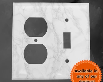 May include: White marble patterned wall plate with a single light switch and a double outlet. The plate is available in other designs.