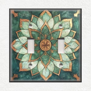 May include: A green and gold mandala light switch cover with a decorative floral design.