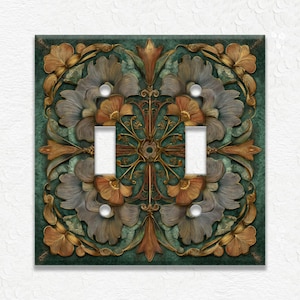 May include: Decorative double light switch cover with a floral design. The cover features a teal background with detailed, embossed flowers in shades of gold, brown, and gray. The switch plate has two white toggle switches.