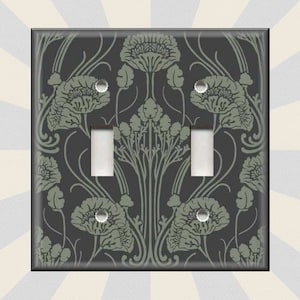 May include: A double light switch cover with a black background and a green floral pattern. The pattern features stylized flowers and leaves.