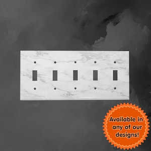 May include: White marble switch plate with four toggle switch cutouts. The plate has a subtle veined pattern. Available in any of our designs!
