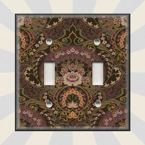May include: A double light switch cover with a decorative floral pattern in shades of brown, green, purple, and orange.