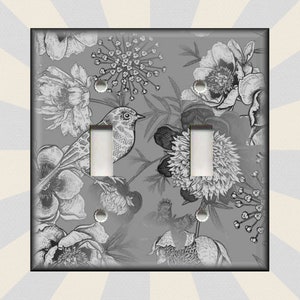 May include: A gray light switch cover with a black and white floral pattern and a small bird. The floral pattern includes peonies, leaves, and other flowers.