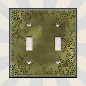 May include: A double light switch cover with a green background and a black leafy pattern.