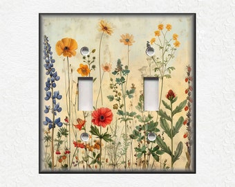 May include: A light switch cover featuring a vintage botanical illustration of a variety of wildflowers in shades of yellow, red, blue, and green on a cream background.