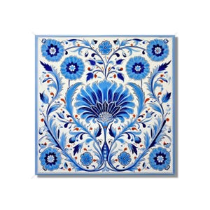 May include: A blue and white ceramic tile with a floral design. The tile features a large blue flower in the center surrounded by smaller blue flowers and leaves. The background is white.