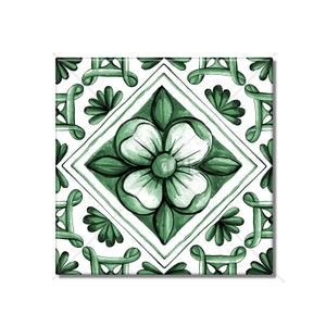 May include: A green and white ceramic tile with a floral design. The tile features a large, stylized flower in the center, surrounded by a geometric pattern of smaller leaves and swirls.