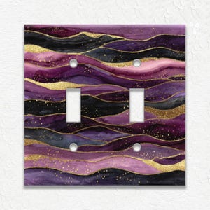 May include: A set of three ceramic mugs with a speckled, matte finish. The mugs are in shades of cream, light gray, and dark gray. Each mug has a simple, minimalist design, perfect for coffee or tea.