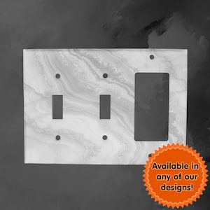 May include: A white marble-patterned light switch cover with two toggle switches and a single outlet.  Available in any of our designs!
