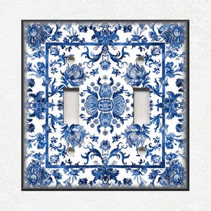 May include: A white light switch cover with a blue and white floral pattern. The pattern is reminiscent of traditional Chinese porcelain.