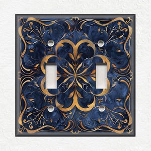 May include: A decorative light switch cover with a blue and gold design. The design features intricate floral patterns and swirls.