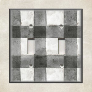 May include: A black and white checkered light switch cover with a watercolor effect.