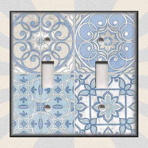 May include: A light blue and white patterned light switch cover with a distressed look. The pattern is reminiscent of traditional tile designs.
