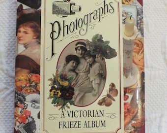 May include: A vintage book cover with a red and cream color scheme. The title is "Photographs: A Victorian Frieze Album". The cover features a collage of Victorian-era images, including portraits, flowers, and a camera.
