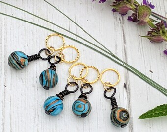Turquoise striped bead stitch markers with closed gold ring
