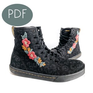 May include: Black high-top canvas boots with floral embroidery and a leopard print pattern. The boots have a black rubber sole and laces.