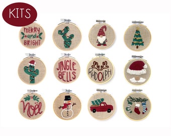 May include: A collection of twelve embroidery hoop kits with Christmas-themed designs. Each kit features a different festive image, including a cactus with lights, a gnome, a Christmas tree, and the words "Merry and Bright" and "Jingle Bells."