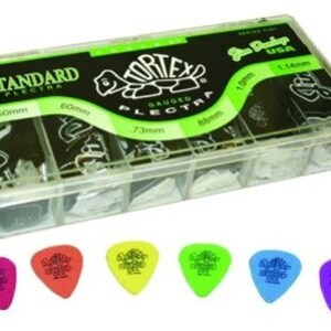 May include: A clear plastic box filled with guitar picks. The box has a green and black label that says "Tortex Gauged Plectrum" and "Standard Plectrum". The box contains 10 picks in different sizes, ranging from 0.50mm to 1.14mm. The picks are in a variety of colors, including green, yellow, orange, and purple.