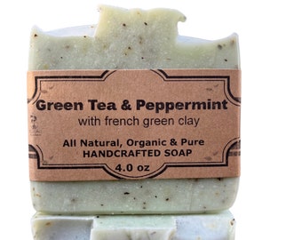 May include: Two bars of green tea and peppermint soap with a brown label that reads "Green Tea & Peppermint with french green clay All Natural, Organic & Pure HANDCRAFTED SOAP 4.0 oz"