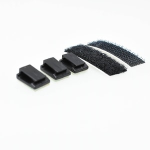 May include: Four black adhesive cable clips with a white adhesive backing and two strips of black hook and loop fastener.